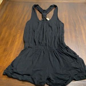 Stretchy black tank top romper features pockets in the shorts. Size small.